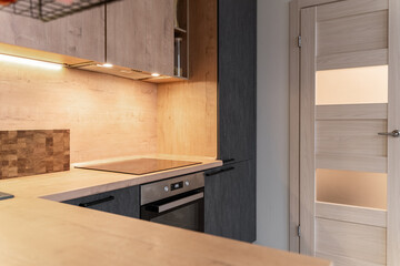 large modern grey kitchen with wooden furniture and appliances