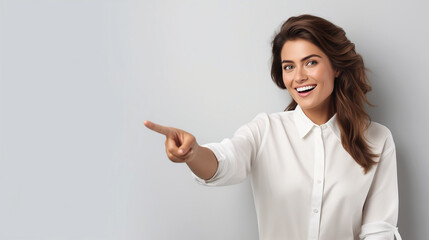 Mockup for advertising with happy female model, pointing to the side at background wall for marketing graphics, space for branding copy and sale deal announcement, blank background