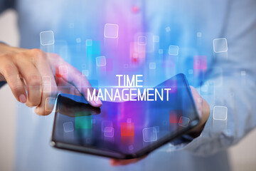 Young man holding a foldable smartphone