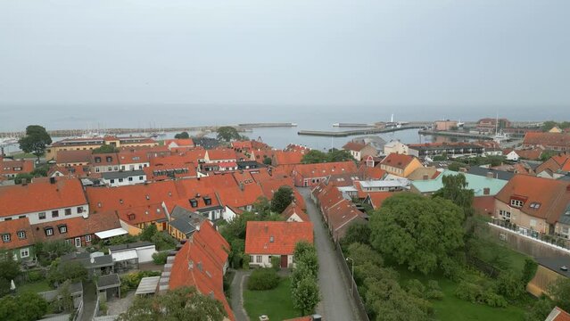 Picturesque houses in coastal town Simrishamn, Sweden. Forward drone shot