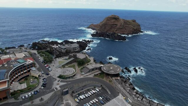 Drone flight over Madeira helicopter platform by scenic ocean rock formation