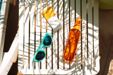 Sunscreens, sunglasses and a delicious chilled cocktail on the pool table