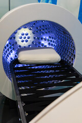 Vertical solarium in the shape of a futuristic capsule chair with LED lighting inside