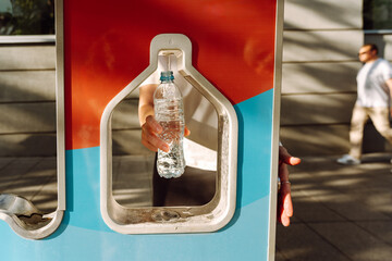 Woman refilling her water bottle at city. Free public water bottle refill station. Sustainable and...