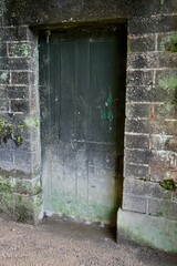 Rustic painted ancient doorway in a stone wall, England, UK. 