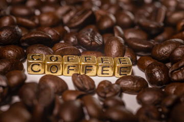 Coffee beans and the inscription coffee on a white background.