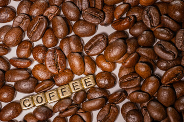 Coffee beans and the inscription coffee on a white background.