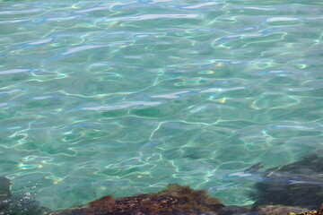Wonderful image of rippled sea water with turquoise blue and green colors - obrazy, fototapety, plakaty