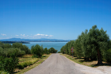 Fototapeta na wymiar The Trasimeno lake at summer near Torricella and Monte del Lago