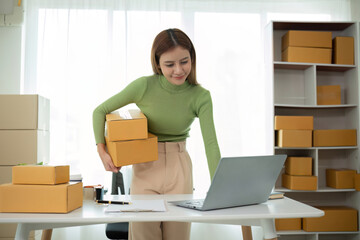 Business From Home Asian woman preparing package delivery box Shipping for shopping online. young start up small business owner at home online order