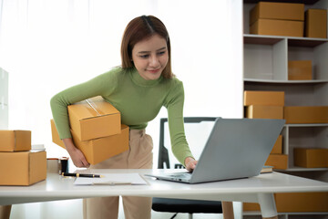 Business From Home Asian woman preparing package delivery box Shipping for shopping online. young start up small business owner at home online order