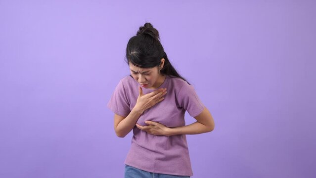 Asian girl is coughing because of sore throat
