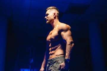 Fototapeta na wymiar Handsome muscular man posing in the gym