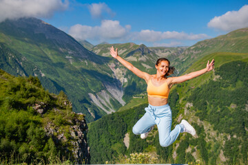 Woman Wearing Blue Suit Standing Against Breathtaking Mountain Background with Blue Sky and Trees