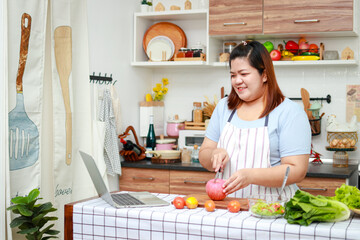 Fat Asian woman takes cooking class online on social media using laptop computer. Weight loss food. social media