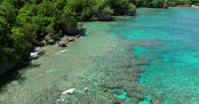 Coral Reef Under Crystal-Clear Blue Waters In Moso Island, Vanuatu. drone tilt-up shot