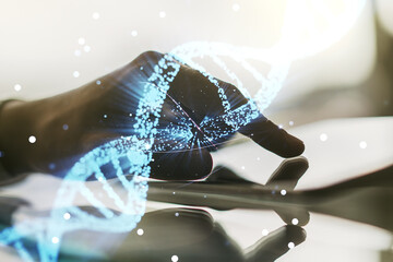 Creative DNA sketch and hand working with a digital tablet on background, biotechnology and genetic...