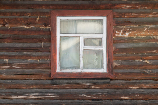 window on the facade of an old wooden house