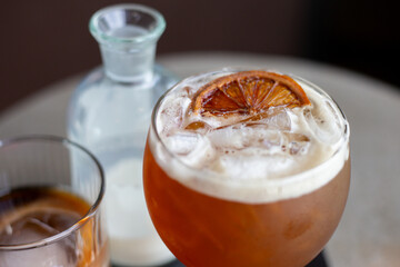 selective focus, cool, fizzy drinks with ice Craft cola with white foam Decorate with a lemon slice on top. A refreshing drink made from herbs. At the Chiang Mai cafe