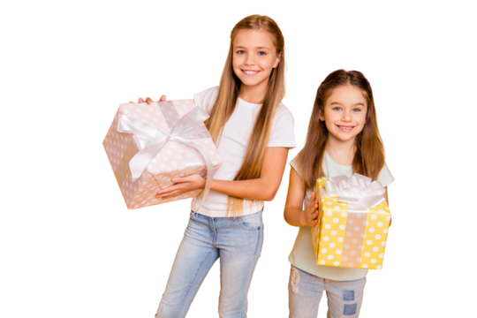 Portrait of two nice cute sweet attractive cheerful cheery pre-teen girls holding in hands large boxes isolated over bright vivid shine yellow background