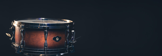 Snare drum on a dark background isolated with space for a text.