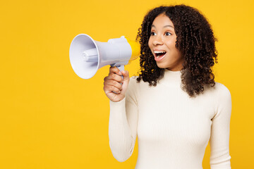 Little kid teen girl of African American ethnicity wear white casual clothes hold megaphone scream...