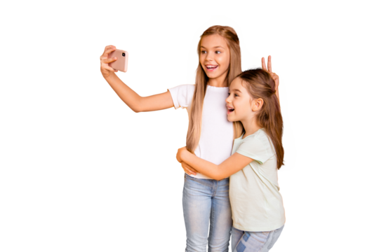 Portrait of two nice attractive lovely cheerful cheery positive girlish girls showing v-sign like hare ears fooling making selfie isolated over bright vivid shine yellow background