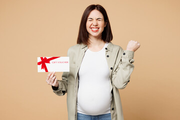 Young pregnant woman future mom wear grey shirt with belly stomach tummy with baby hold store gift...