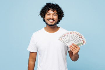 Young happy Indian man he wear white t-shirt casual clothes hold in hand fan of cash money in...