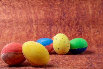 Colorful easter eggs on a wooden background. Easter holiday concept.