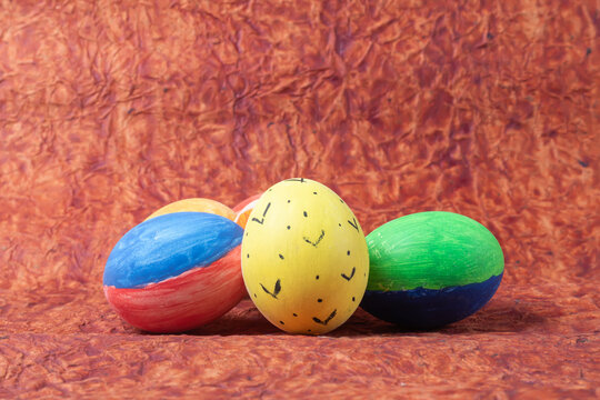 Colorful easter eggs on a brown background with copy space