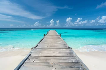 Foto op Plexiglas Wooden pier leading to the ocean with a white sand beach and turquoise water, tropical island background, copy space for text in a wide format in the style of tropical island background.  © Denis