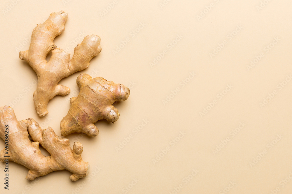 Wall mural Finely dry Ginger powder in bowl with green leaves isolated on colored background. top view flat lay