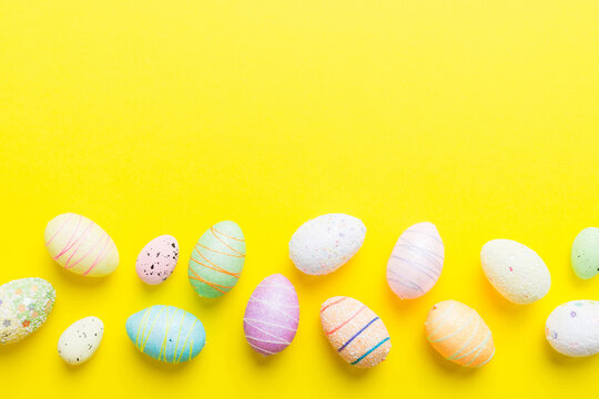 decorative easter eggs on colored background. easter eggs collection top view with copy space