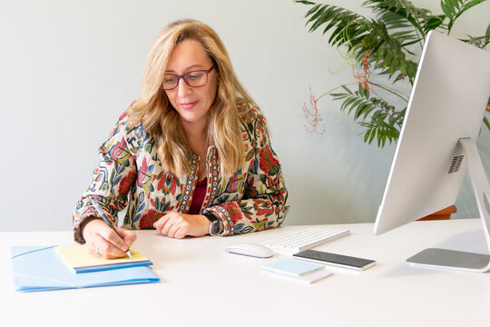 Professional woman working at a modern office desk