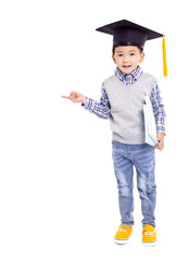 Happy Asian school kid graduate in graduation cap and hand pointing to copy space