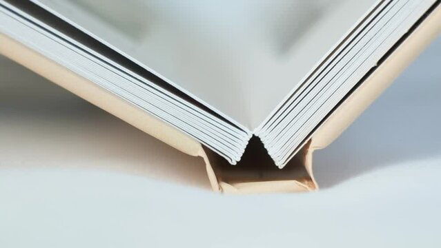 Photo album book with photos opens, close-up slow motion