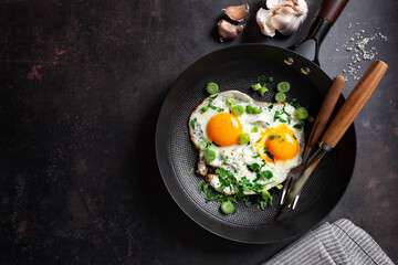 Fried eggs with vegetables on pan - 767049678