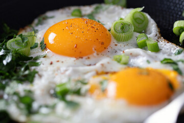 Fried eggs with vegetables on pan - 767049695