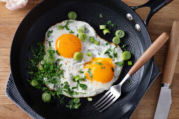 Fried eggs with vegetables on pan - 767049699