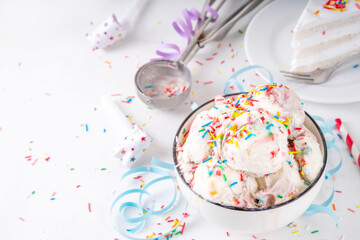 Birthday cake ice cream. Bowl portion of birthday cake taste white vanilla ice cream with colorful sugar sprinkles, funfetti with happy birthday decorations on table, copy space