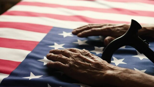hands of a pensioner and a walking cane on the usa flag. symbols of America in the hands of an old man, independence day, obtaining American citizenship, history of the state