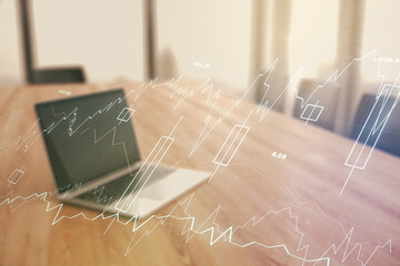 Abstract creative financial graph on modern laptop background, forex and investment concept....