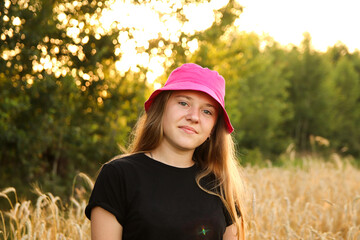 A charming portrait of a teenage girl in her mid-teens, donning a stylish Panama hat. Girl 15s age, portrait. Summer outside