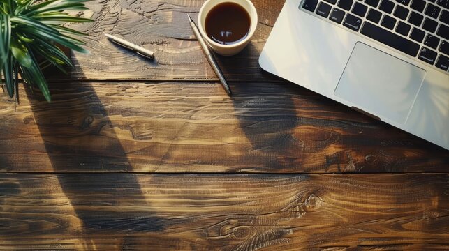 Notebook, pen, laptop, and coffee on wood table