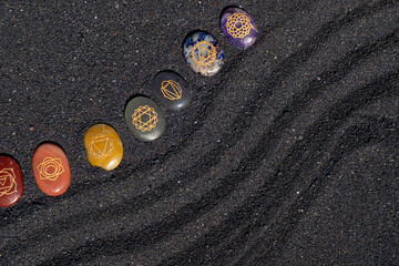 Healing crystals on black sand background