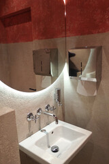 Modern bathroom interior with illuminated mirrors