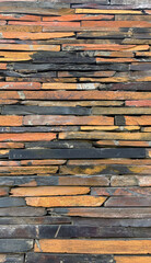 Closeup Wall constructed with stacked stone slabs, abstract vertical background. High quality photo