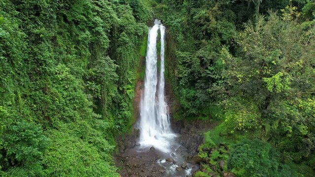 Forward reveal aerial footage of Gitgit waterfall. Bali, Indonesia.
