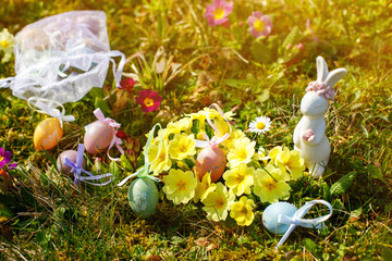 Easter bunny with Easter eggs on the grass at Easter.